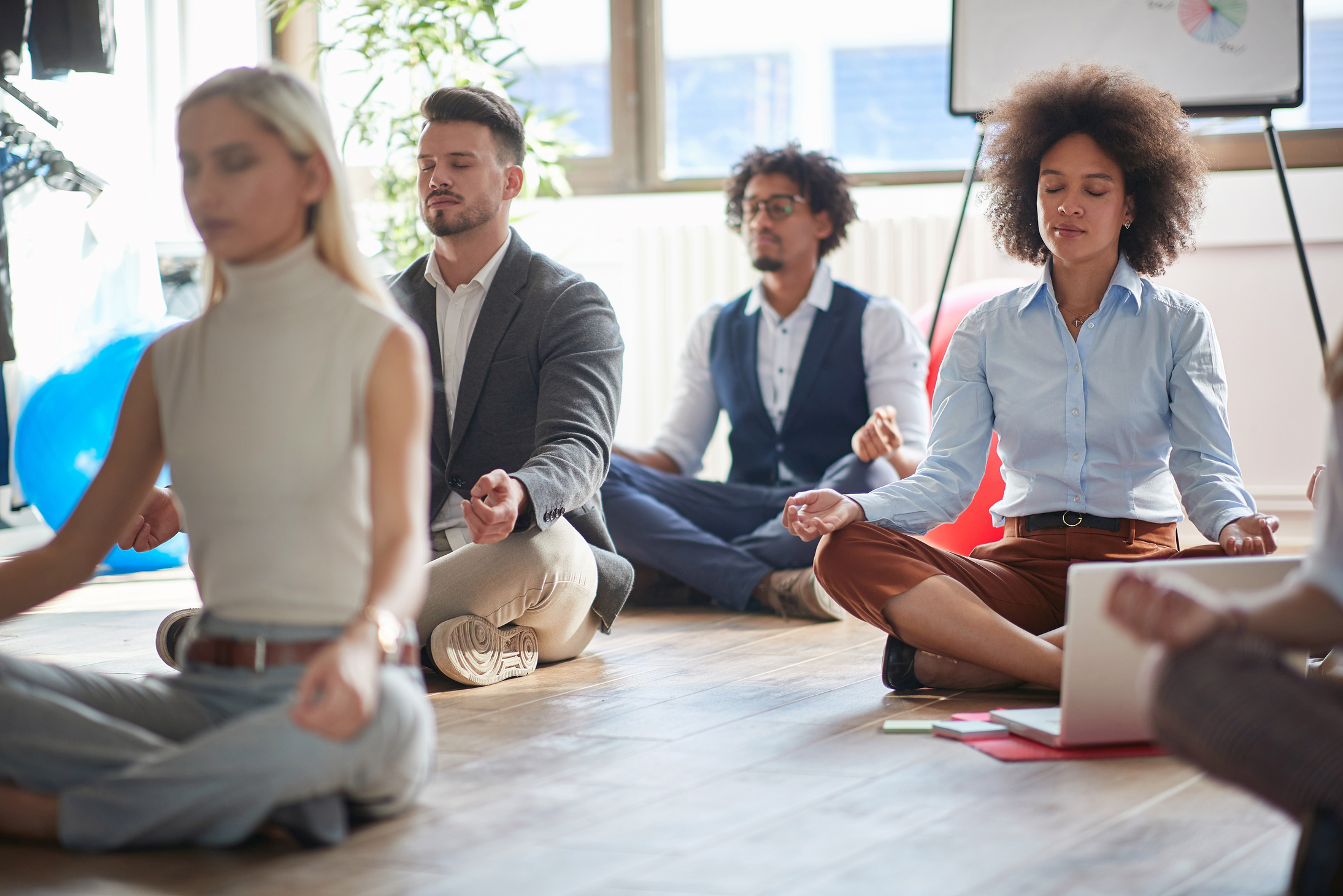 Office workers meditating at work.Meditating at office.